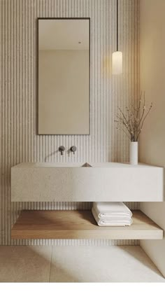 a white sink sitting under a mirror next to a wall mounted faucet in a bathroom