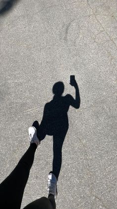 the shadow of a person holding a cell phone