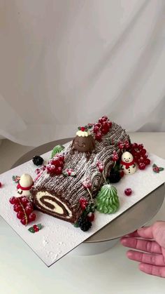 a cake is decorated with berries and chocolate