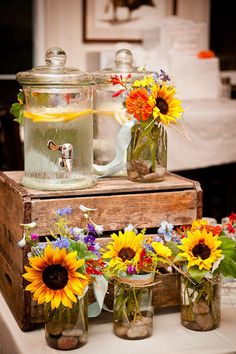 sunflowers and mason jars are sitting on a table