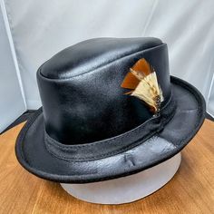 Need A Leather Fedora Hat That Can Travel Without Losing Its Shape, And That Looks Great With Any Outfit At Any Venue? This Nearly Impossible Combination Of Qualities Is Perfectly Embodied By The Soho Rocky Leather Packable Trilby. Featuring A Super Comfortable Removable Sweatband Liner That Attaches Securely With Velcro Tabs Sewn Into The Hat. Brim Measures 1 1/4" Crown Measures 3 1/4" Lightweight Usa Raised Cowhide Leather Unfinished | Natural All-Leather Trilby Style Fedora Water-Resistant An Fitted Leather Fedora Hat, Black Leather Brimmed Top Hat, Vintage Top Hat With Short Brim For Fall, Black Leather Top Hat With Flat Brim, Vintage Short Brim Top Hat For Fall, Fitted Leather Hat With Short Brim, Black Leather Hat With High Crown, Fitted Leather Hat With Curved Brim, Fitted Leather Top Hat With Short Brim