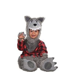 a little boy dressed in a costume that looks like a wolf sitting on the ground