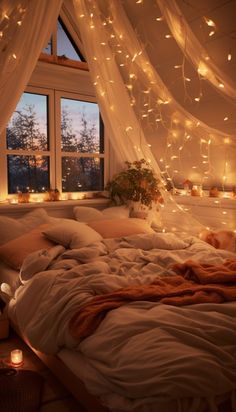 an unmade bed in front of a window with fairy lights hanging from the ceiling