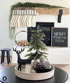 a christmas tree in a basket on top of a coffee table next to a fireplace