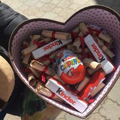 a heart shaped box filled with lots of candy