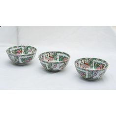 three bowls with designs on them sitting next to each other in front of a white background