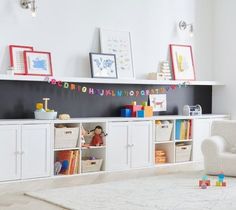 a child's playroom with white furniture and toys