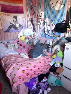 a bed covered in lots of stuffed animals