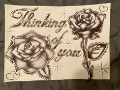 a piece of paper that says thinking of you with two roses and hearts on it