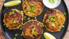 several crab cakes in a skillet with parsley on top