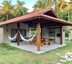 a small house with hammocks in the yard