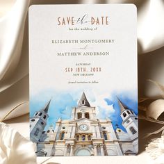 a wedding save the date card with an image of a castle and clock on it