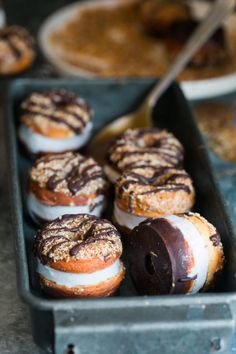 there are many donuts in the tray on the table and ready to be eaten