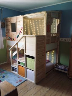 there is a bunk bed with stairs and lights on the top floor in this room