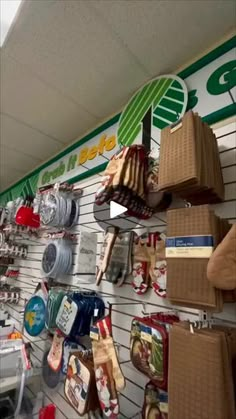 there are many items hanging on the wall in this store that is decorated with green and white stripes