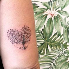 a small tree tattoo on the arm