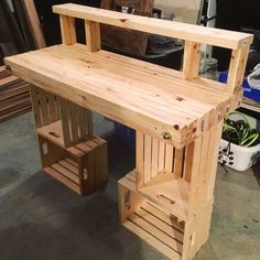 a wooden bench made out of pallet wood in a garage with other tools nearby