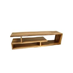 a wooden shelf sitting on top of a white wall