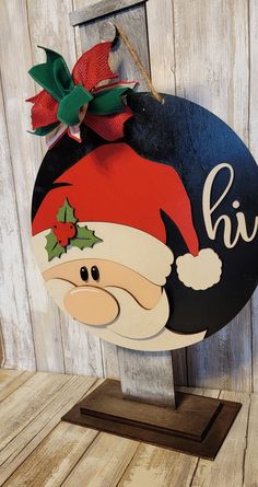 a wooden sign with a santa hat on it