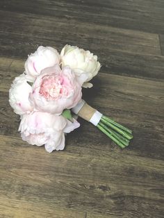 a bouquet of flowers sitting on top of a wooden table