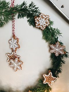 some cookies are hanging from a christmas wreath