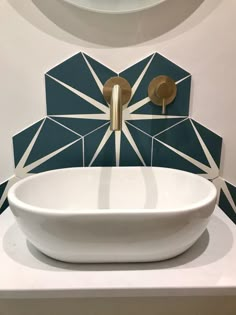 a white bowl sink sitting on top of a counter next to a wall mounted faucet