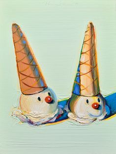 two ice cream cones shaped like snowmen laying on top of each other with their heads down