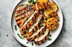 grilled chicken with lemons and parsley on a plate