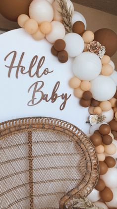 a hello baby sign surrounded by balloons and other decorations