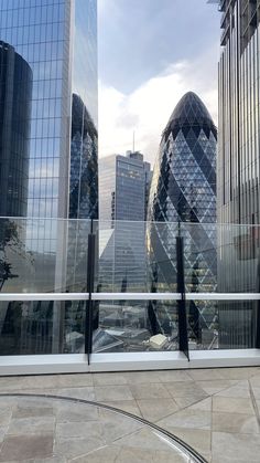 the city skyline is reflected in the glass walls of this building's roof terrace