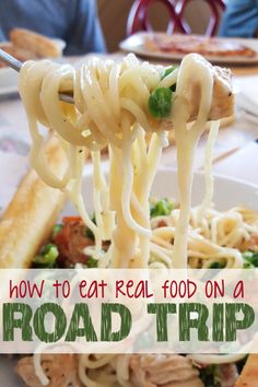 a close up of food on a fork with the words how to eat real food on a road trip