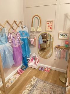 there are many princess dresses hanging on the wall