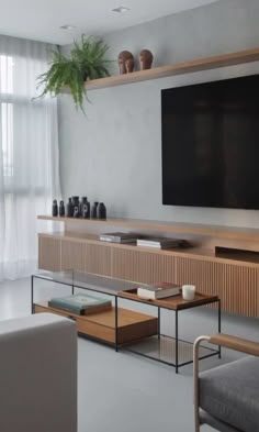 a large flat screen tv mounted to the side of a wall in a living room