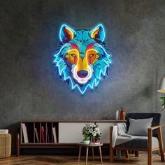 a neon wolf head mounted on the side of a gray wall next to a chair