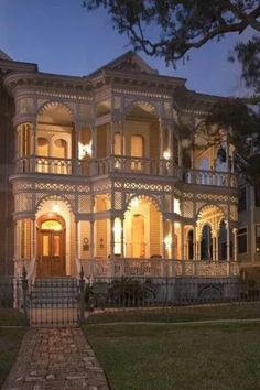 an old victorian house lit up at night