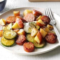 a white plate topped with potatoes and vegetables