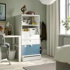 a white and blue bookcase in a room with a chair, desk and window