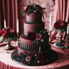 a three tiered cake with flowers and berries on the top is surrounded by candles