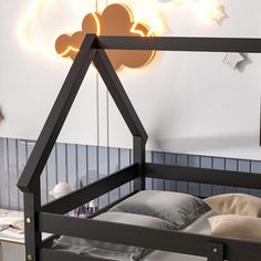 a child's bed with mickey mouse lights above it