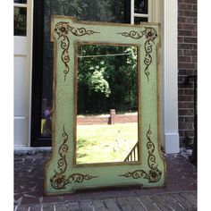 a mirror sitting on top of a brick sidewalk