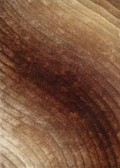 the wood grain is brown in color and it looks like an abstract piece of art