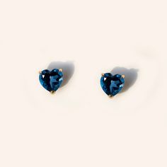 Forever classic, heart-shaped natural London blue topaz stud earrings handcrafted in 9K solid gold. Made to Order. Ship within 3-4 weeks. - Stone info: 5mm heart cut natural London blue topaz - Stone weight: 1.2ctw - Sold as A Pair. - The earrings come with 10K gold silicone backings. - Made in 9 karat gold. - Stamp with 9K. Cheap Handmade Blue Heart Earrings, Lexy Cross, Blue Heart Ring, Stone Earrings Studs, Pokemon Jewelry, Blue Stud Earrings, Gold Topaz, Silver Jewelry Design, Blue Topaz Stone