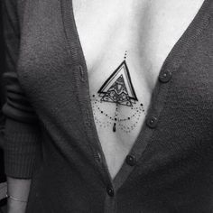 a woman with a triangle tattoo on her chest