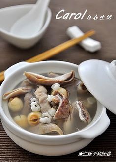 a white bowl filled with soup next to chopsticks