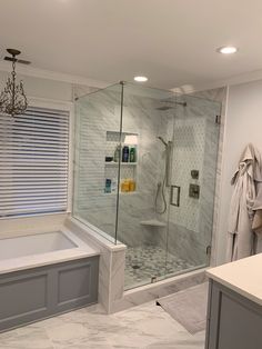 a bathroom with a walk in shower next to a bath tub