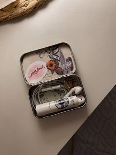 two tins with toothbrushes in them sitting on a table