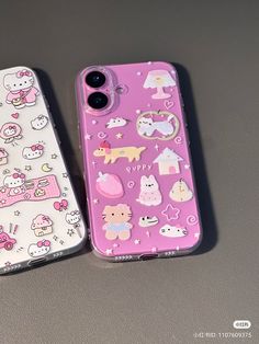 two cell phones with hello kitty stickers on them