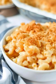 macaroni and cheese in a white bowl on a blue and white table cloth