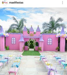 an outdoor wedding venue decorated in pink, blue and yellow with princess castle decorations on the walls