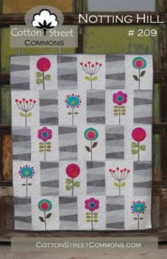 a quilt with flowers on it and the words cotton street commonss next to it